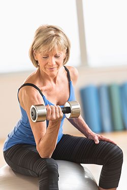 woman exercising dumbell