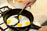 frying eggs on skillet