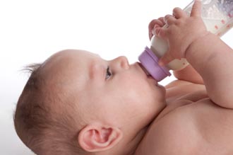 baby drinking artificial human milk