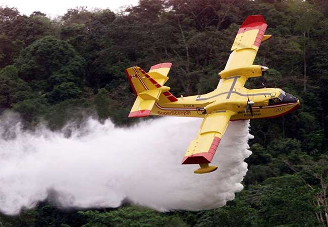 super scoopers fly over the water