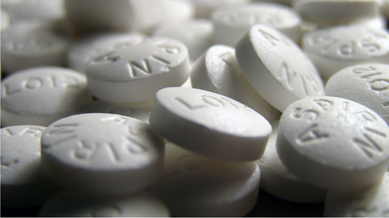 White aspirin tablets piled together