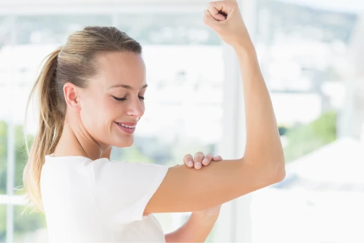 young woman flexing muscles