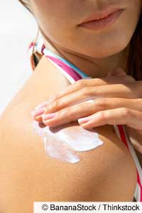 Woman appplying sunscreen